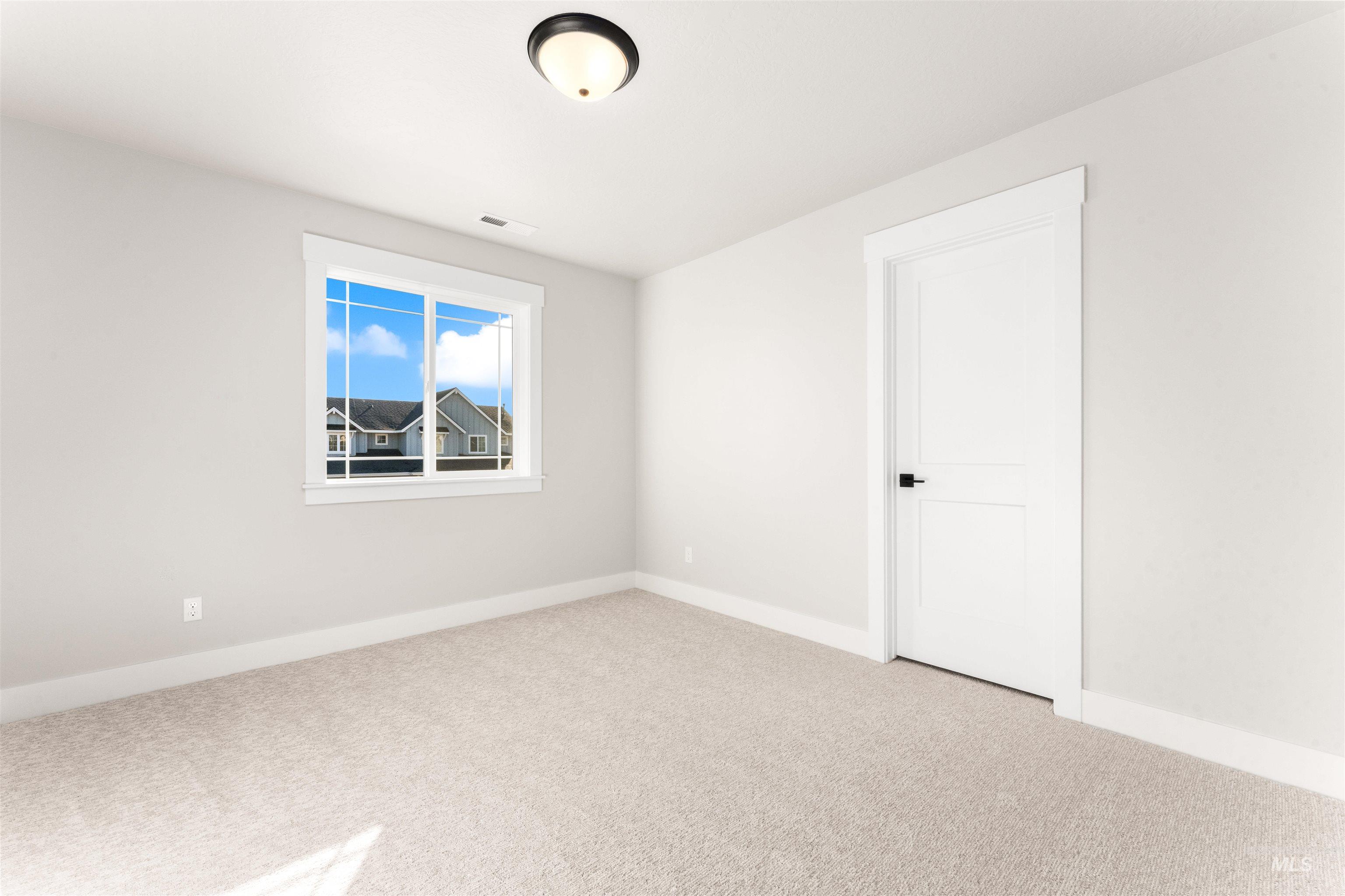 8084 Tandy Cv Street Middleton, ID 83644 - Photo 34 of 46 Empty room featuring baseboards and light colored carpet