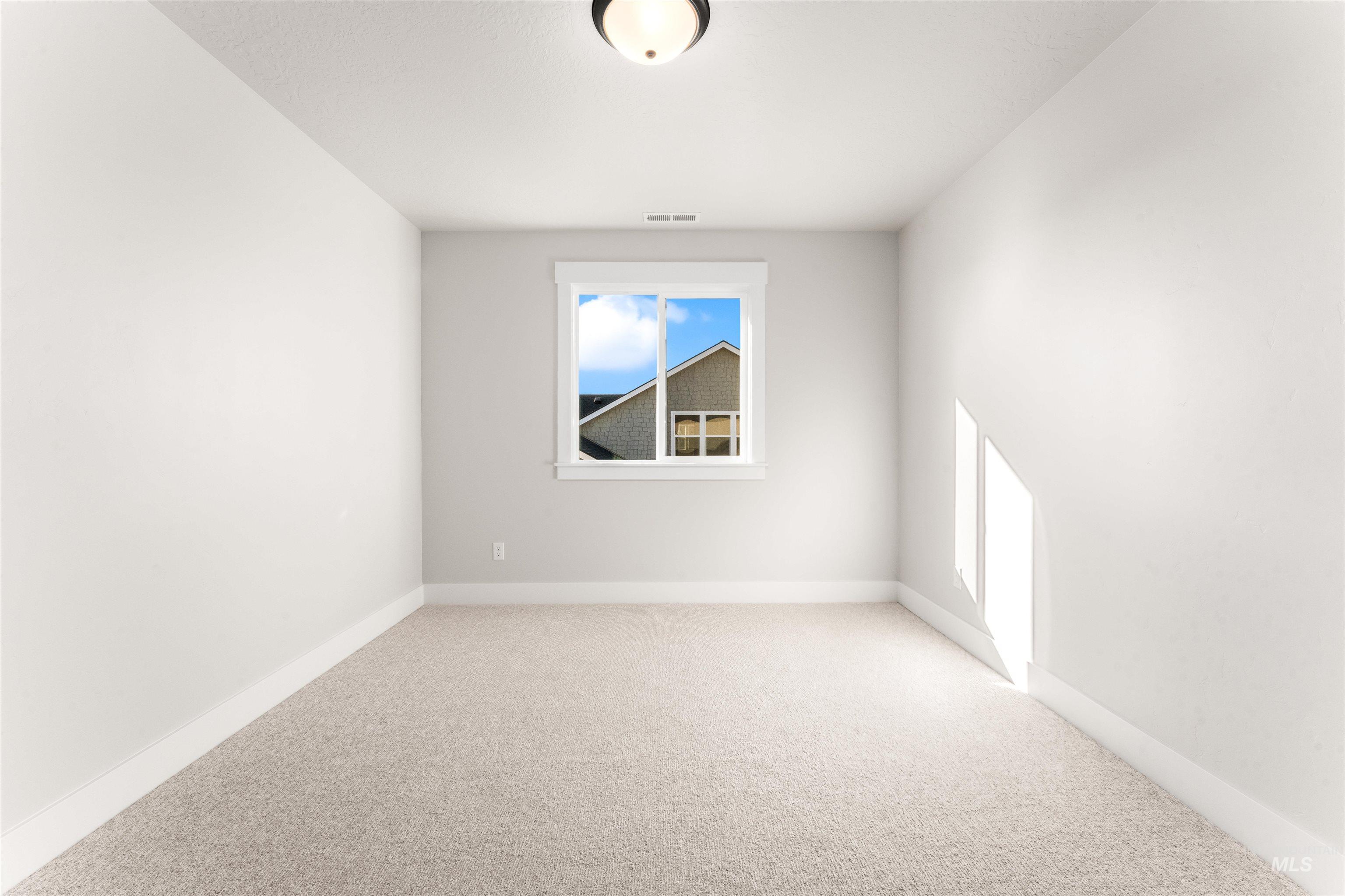 8084 Tandy Cv Street Middleton, ID 83644 - Photo 37 of 46 Unfurnished room with light colored carpet and baseboards