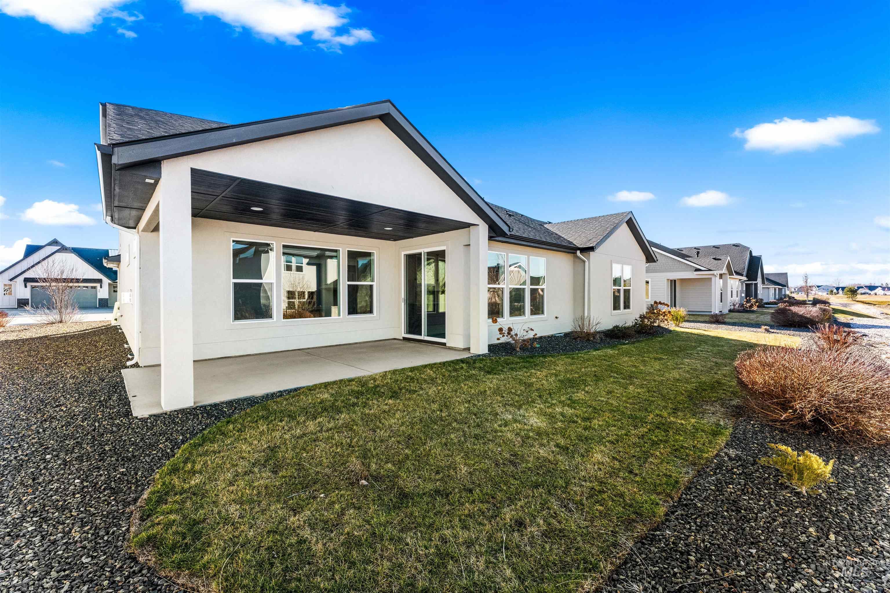 8084 Tandy Cv Street Middleton, ID 83644 - Photo 41 of 46 Rear view of property with stucco siding, a patio, and a lawn