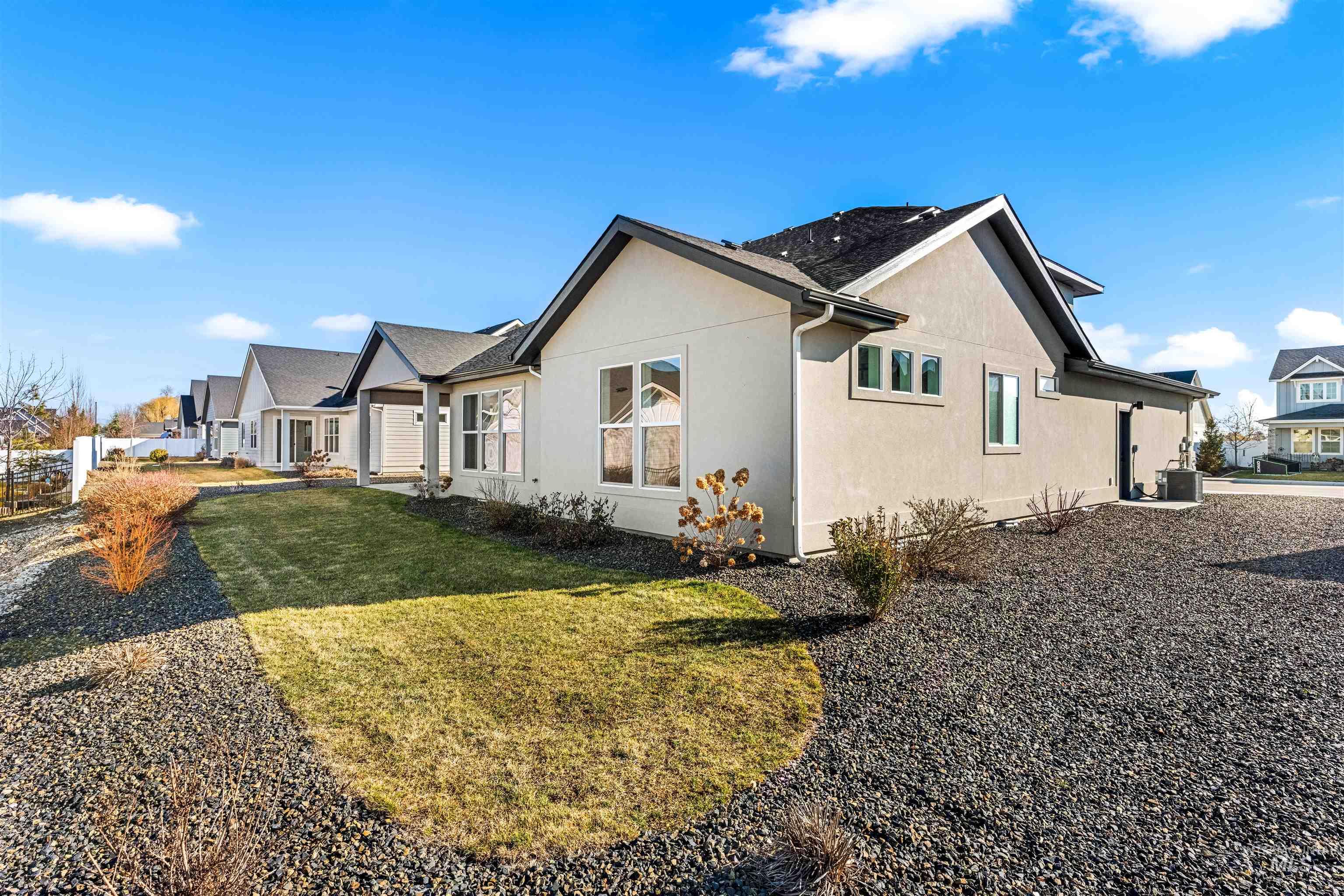 8084 Tandy Cv Street Middleton, ID 83644 - Photo 44 of 46 View of side of home featuring stucco siding and a lawn