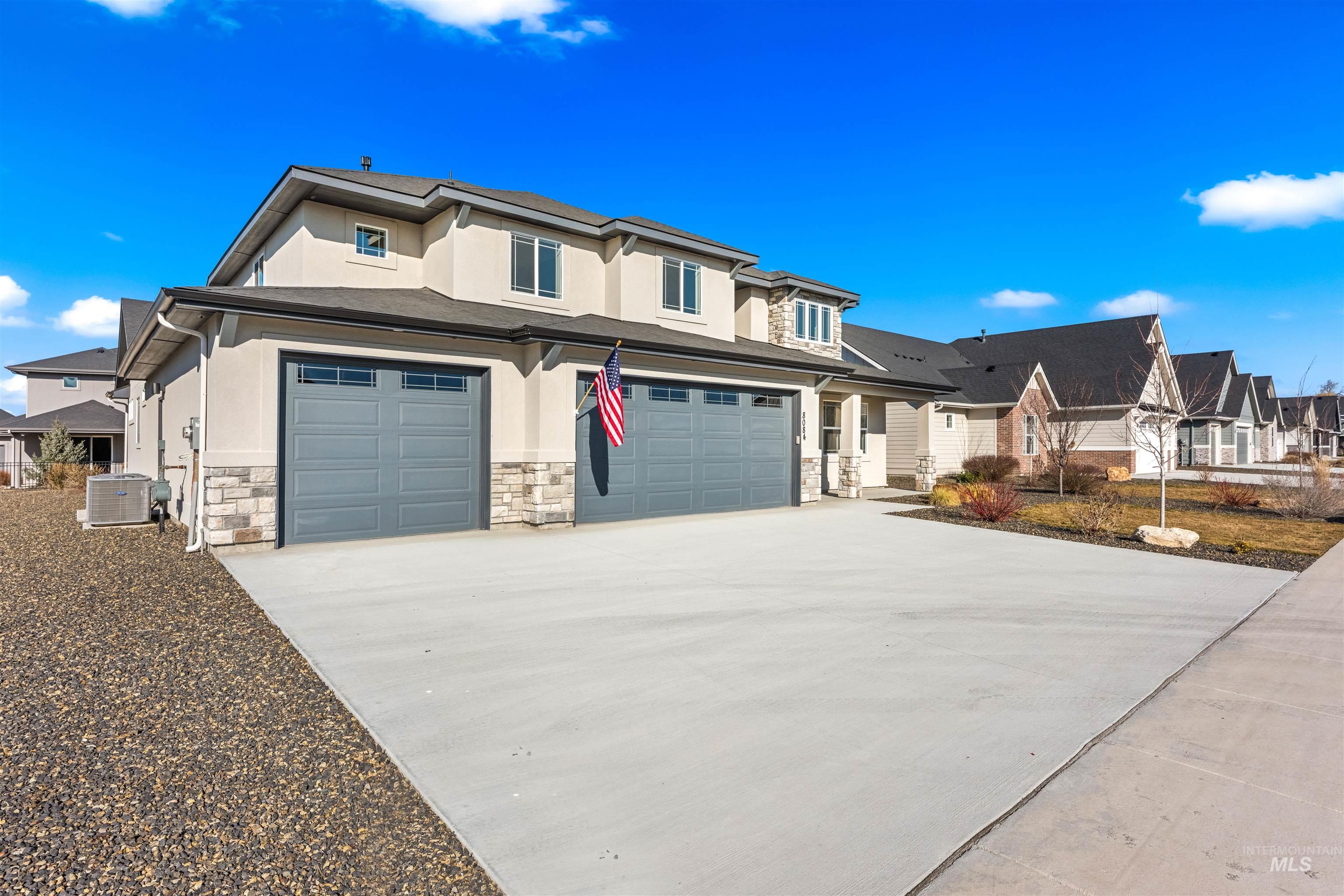 8084 Tandy Cv Street Middleton, ID 83644 - Photo 46 of 46 View of front of property featuring stucco siding, stone siding, concrete driveway, and a residential view