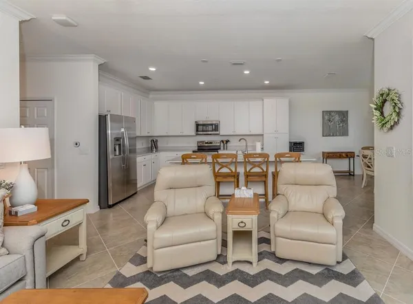 a kitchen with stainless steel appliances granite countertop a dining table and chairs