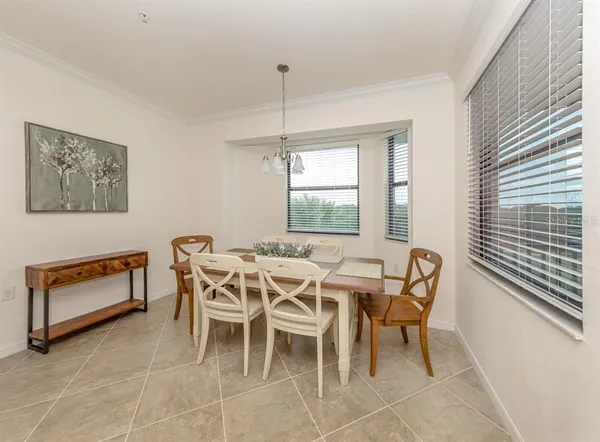 a dining room with furniture and window