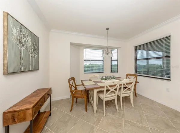 a spacious bedroom with a bed and a flat screen tv