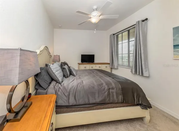 a bathroom with a granite countertop toilet sink mirror and shower
