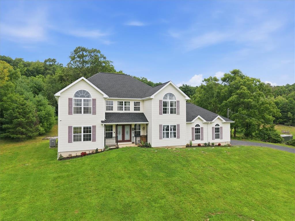 387 Blue Ridge Road Saylorsburg, PA 18353 - Photo 3 of 90 Perched on a grassy hill, this classic two-story home features a welcoming porch and a broad driveway.