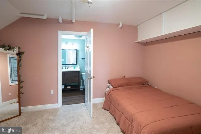 a bedroom with a bed and a hallway