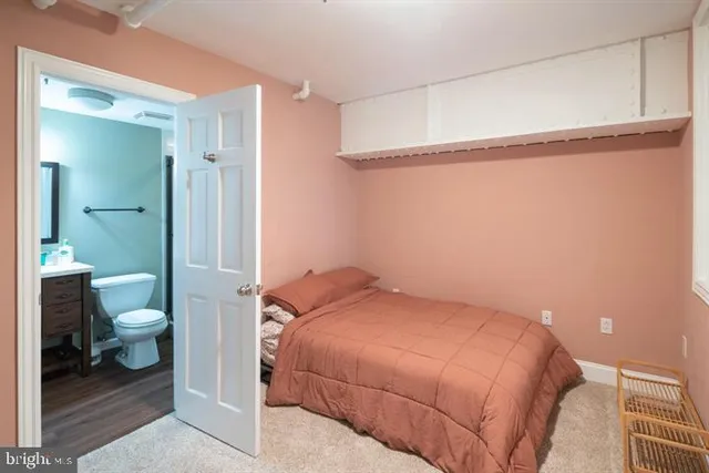 a bedroom with a bed and a view of bathroom