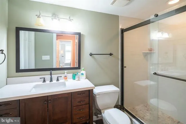 a bathroom with a toilet sink shower and mirror