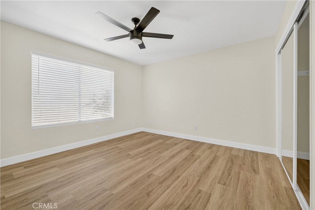 700 West Gonzales Road, Unit F Oxnard, CA 93036 - Photo 2 of 14 wooden floor in an empty room with a window