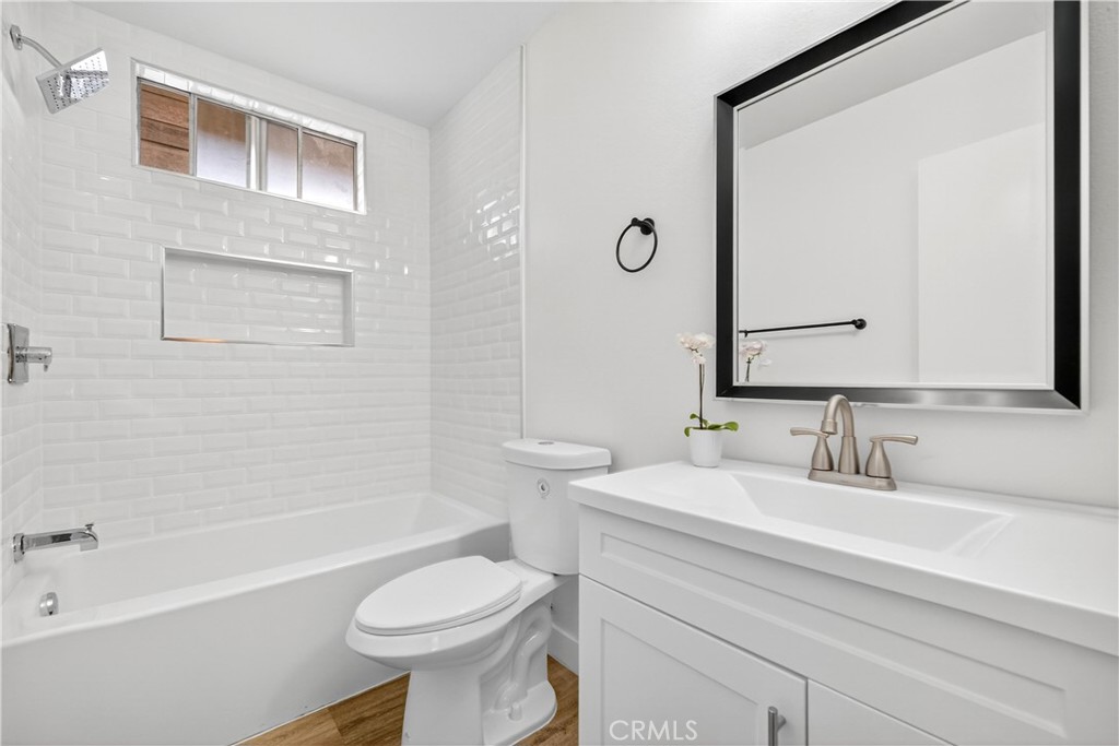 700 West Gonzales Road, Unit F Oxnard, CA 93036 - Photo 4 of 14 a bathroom with a sink a toilet and a bathtub