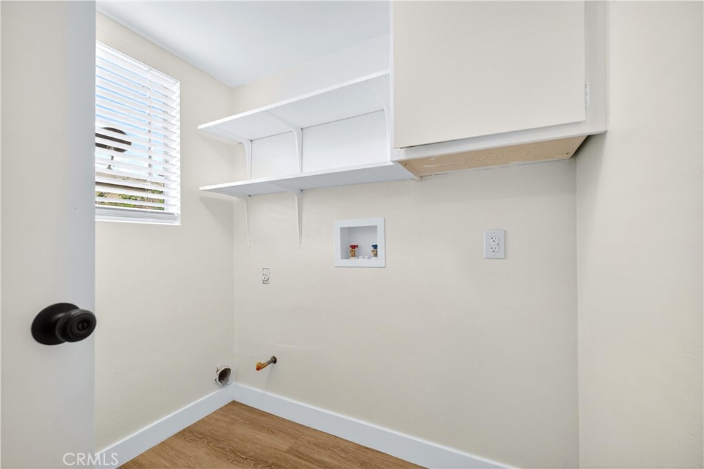 700 West Gonzales Road, Unit F Oxnard, CA 93036 - Photo 10 of 14 a view of an empty room with wooden floor