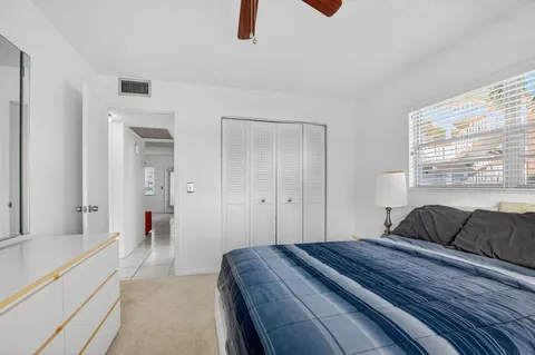 a bedroom with a bed and a large window