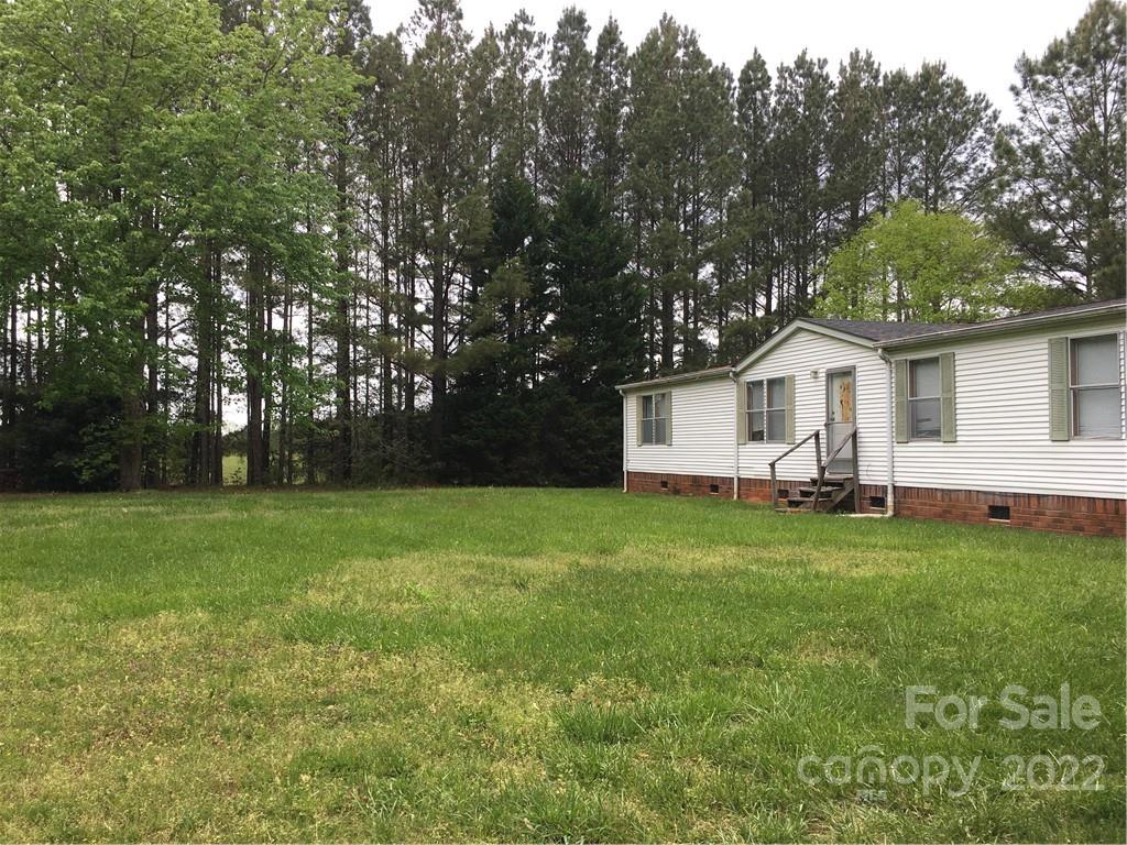 215 Linker Road Rockwell, NC 28138 - Photo 1 of 8 a view of a yard with a house and garden