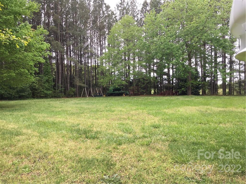 215 Linker Road Rockwell, NC 28138 - Photo 2 of 8 a view of a grassy field with trees in the background
