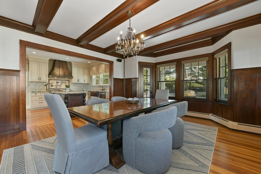 21 Beacon Road Hull, MA 02045 - Photo 13 of 40 a dining room with wooden floor a chandelier a wooden table and chairs