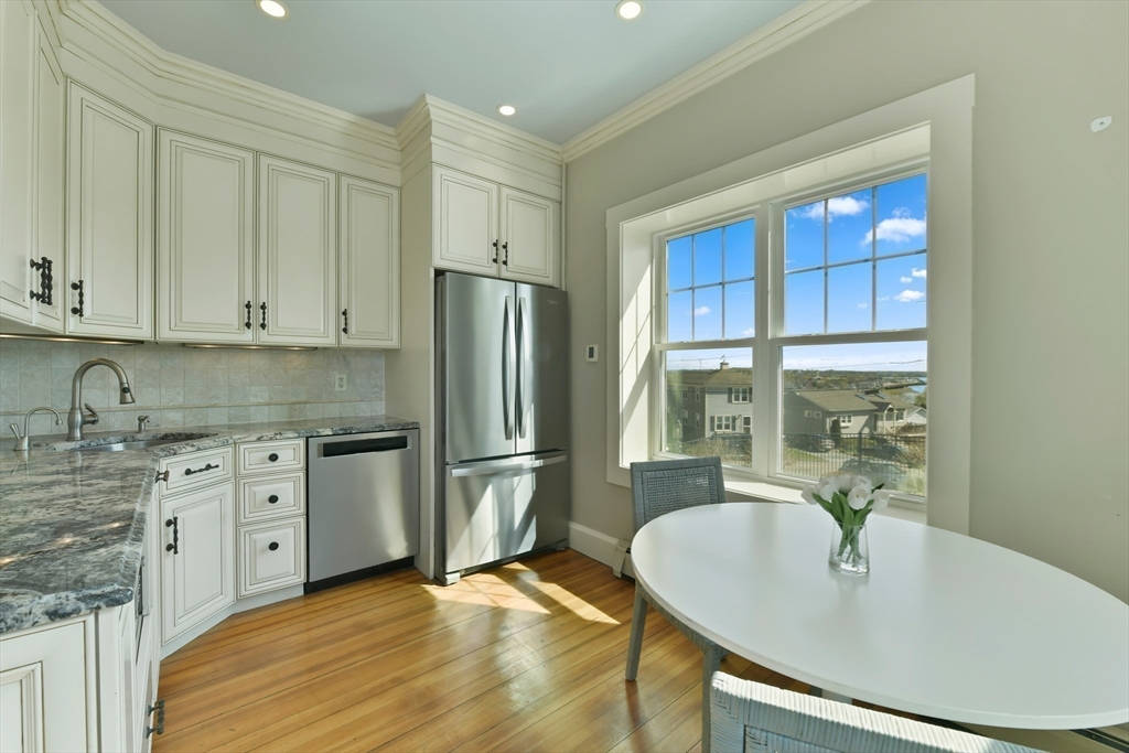 21 Beacon Road Hull, MA 02045 - Photo 18 of 40 a kitchen with stainless steel appliances granite countertop a sink a stove and a refrigerator