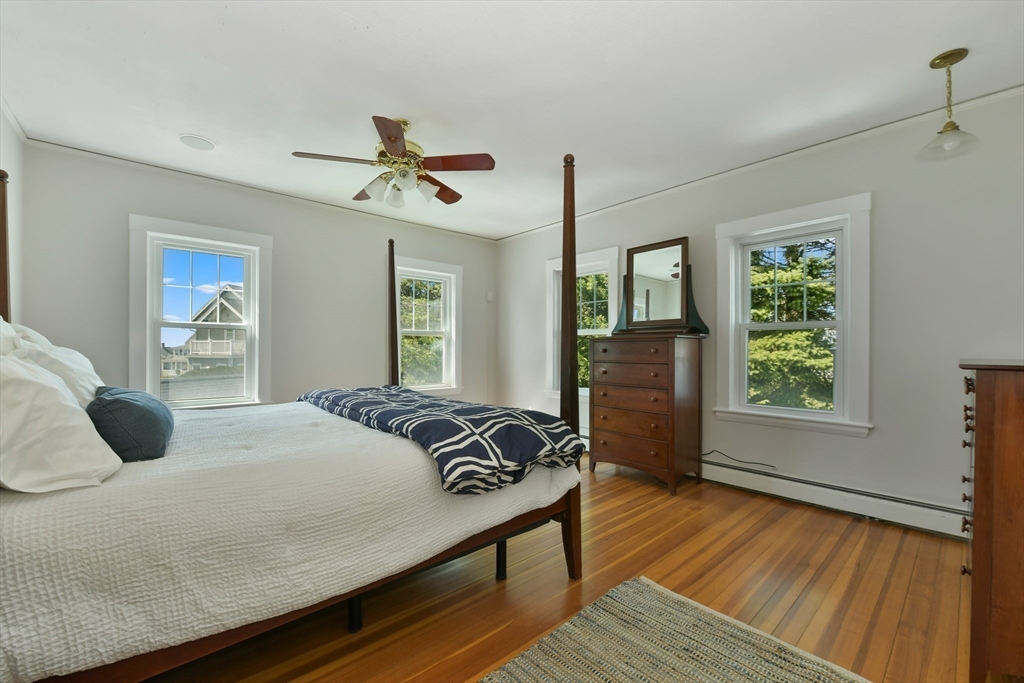 21 Beacon Road Hull, MA 02045 - Photo 19 of 40 a bedroom with a bed and wooden floor