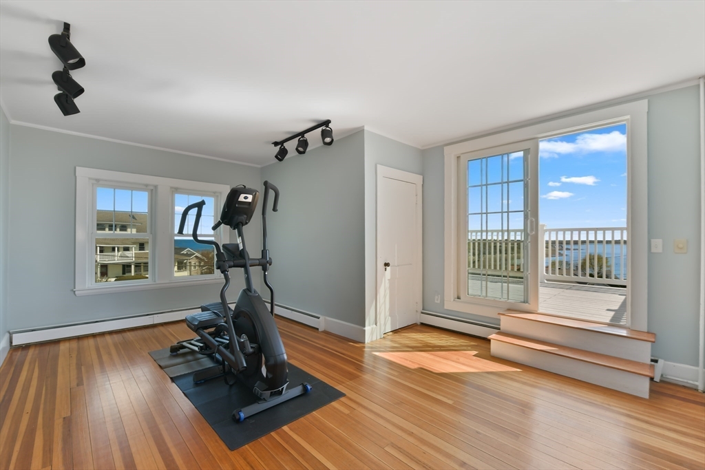 21 Beacon Road Hull, MA 02045 - Photo 21 of 40 a view of a room with gym equipment and floor to ceiling window