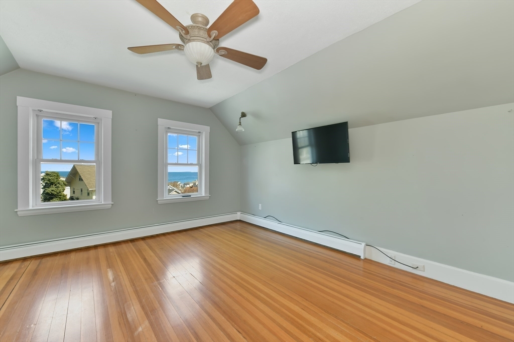 21 Beacon Road Hull, MA 02045 - Photo 23 of 40 an empty room with wooden floor and windows
