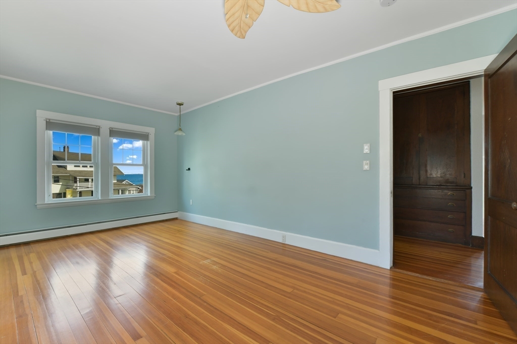 21 Beacon Road Hull, MA 02045 - Photo 25 of 40 a view of an empty room with wooden floor and a window