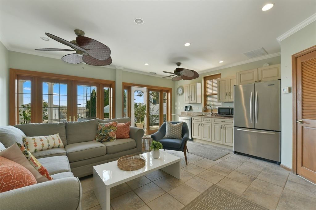 21 Beacon Road Hull, MA 02045 - Photo 30 of 40 a living room with furniture a ceiling fan and a large window