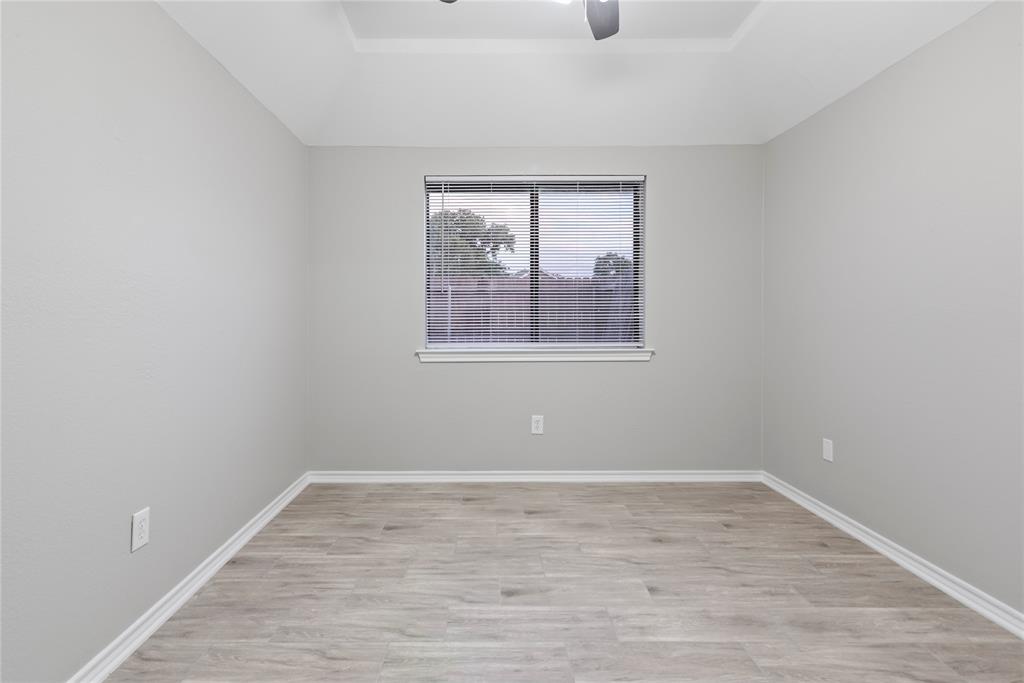 304 Moore Creek Road, Unit 300 Hurst, TX 76053 - Photo 11 of 17 Room featuring light gray walls, wood-finish flooring, and white baseboards