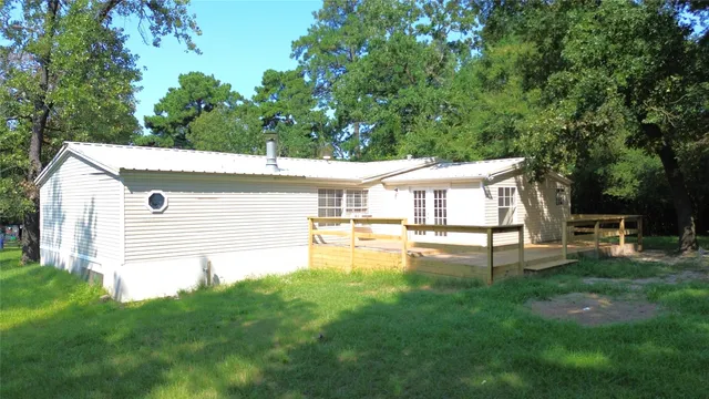 a view of a house with a yard porch and sitting area