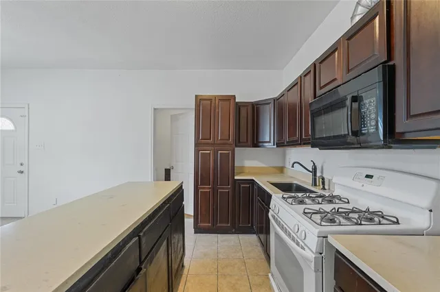 a kitchen with stainless steel appliances granite countertop a stove and a sink
