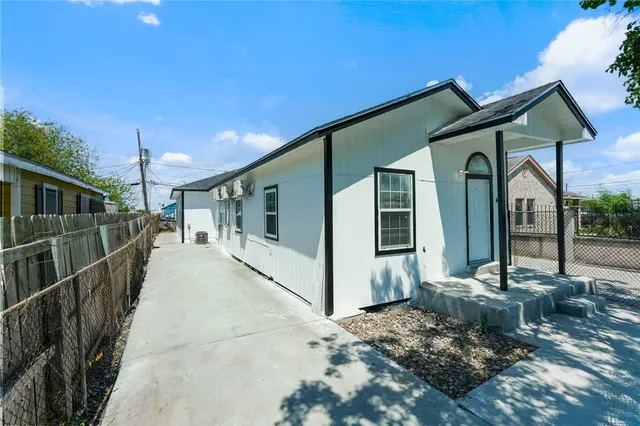 a view of a house with wooden fence