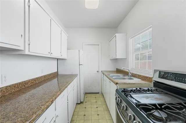 a kitchen with a stove and a sink
