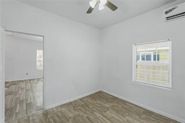 an empty room with a empty space and windows