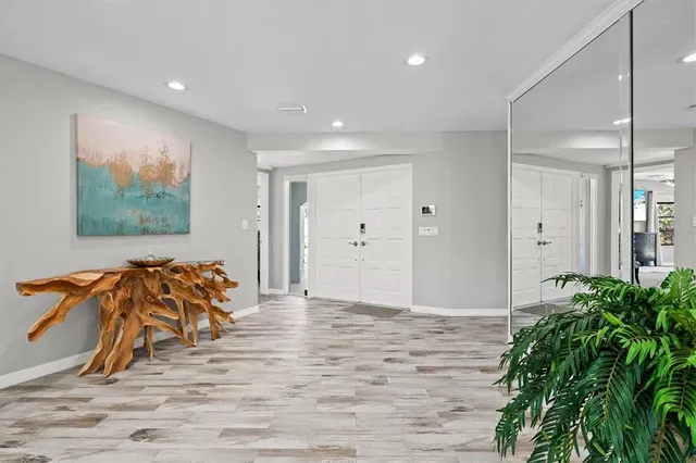 a view of a dining room with furniture and a chandelier