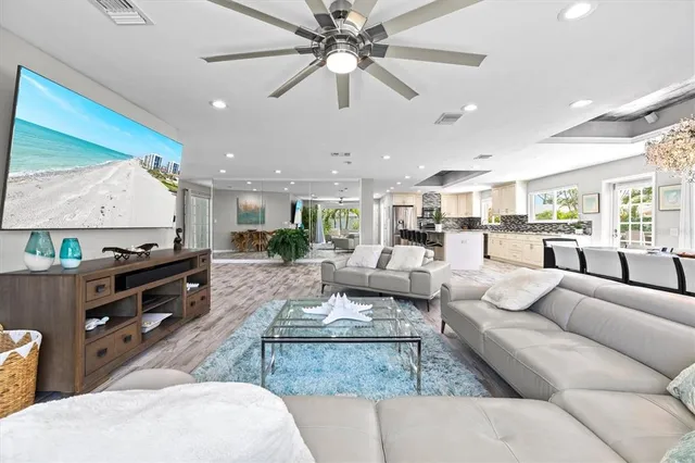 a view of a livingroom with furniture and floor to ceiling window