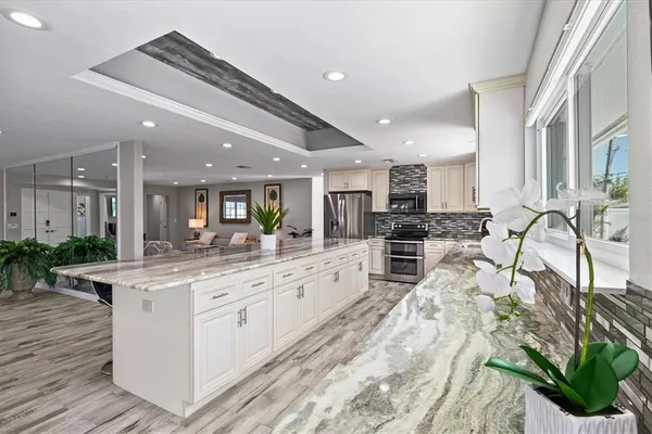 a bathroom with a granite countertop sink a mirror and a shower