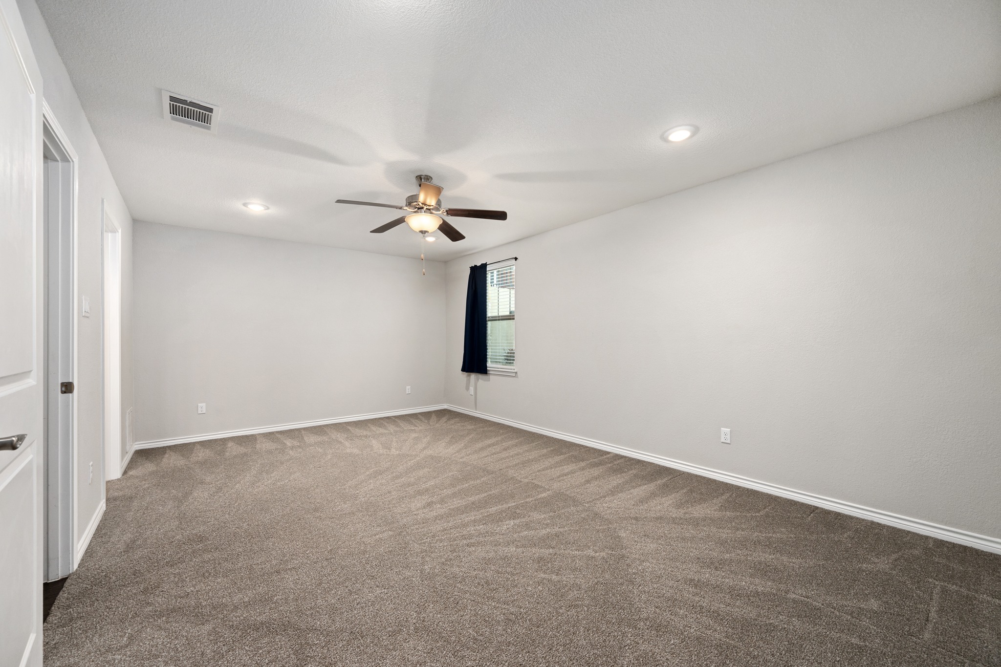 313 Adams Street Georgetown, TX 78628 - Photo 14 of 20 a view of an empty room with a chandelier fan