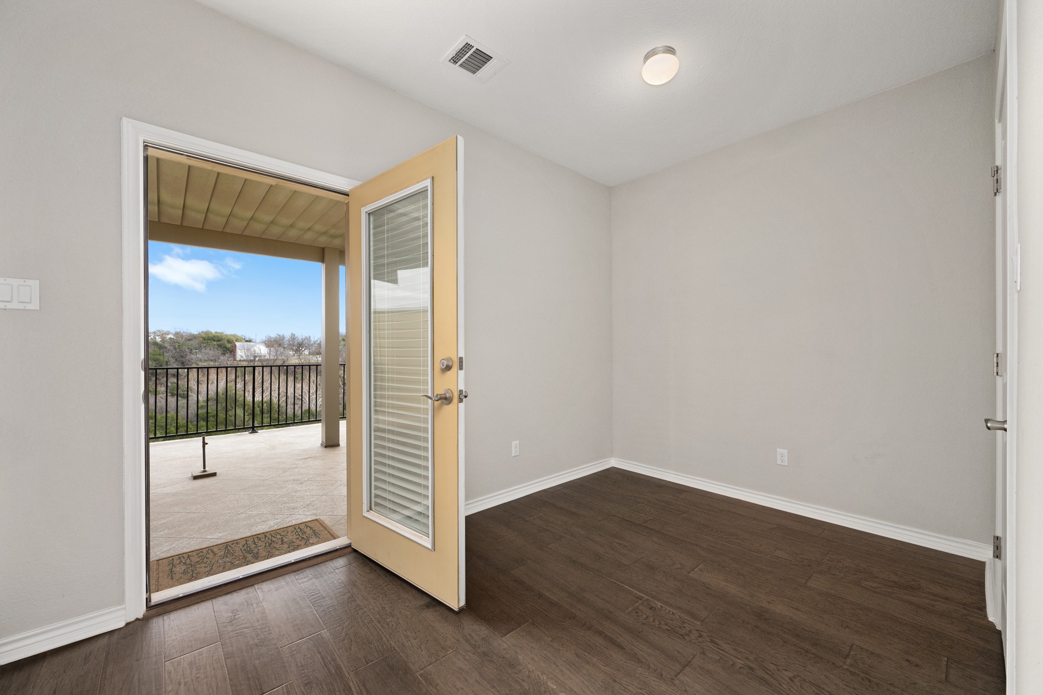 313 Adams Street Georgetown, TX 78628 - Photo 17 of 20 an empty room with wooden floor and windows