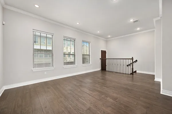 a view of kitchen with cabinets stainless steel appliances and wooden floor