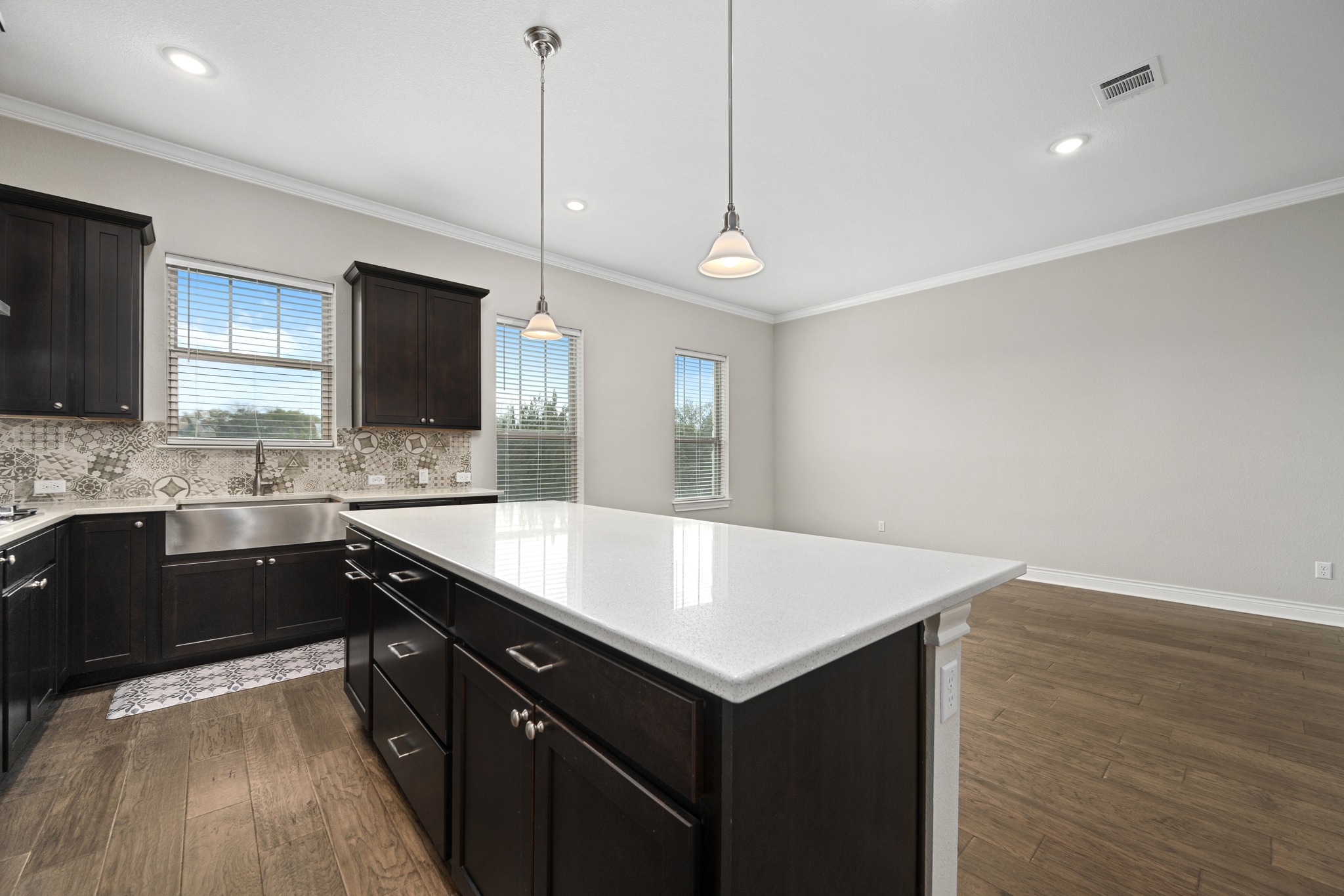 313 Adams Street Georgetown, TX 78628 - Photo 10 of 20 a kitchen with a sink center island and wooden floor