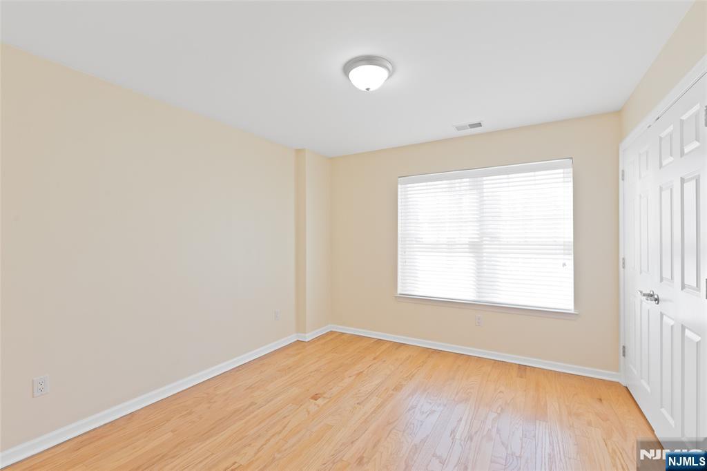 902 Spruce Street Roselle, NJ 07203 - Photo 15 of 32 a view of an empty room with wooden floor and a window