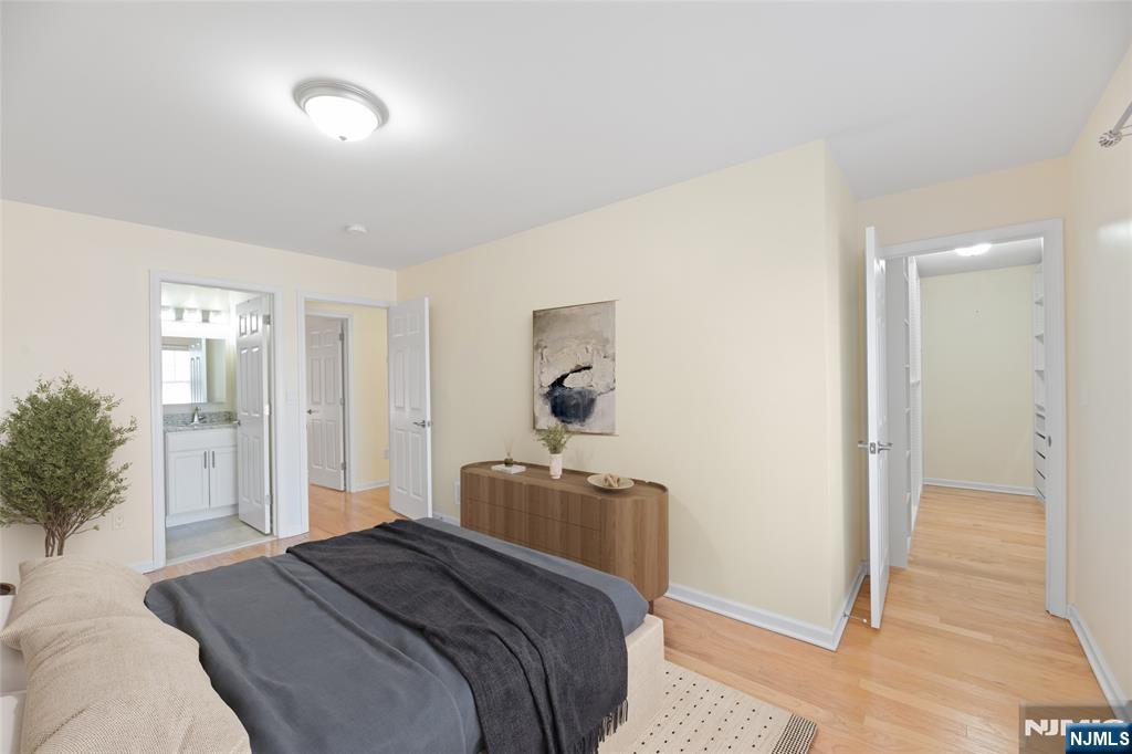 902 Spruce Street Roselle, NJ 07203 - Photo 19 of 32 a bedroom with a bed and a mirror