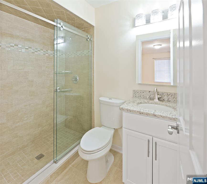 902 Spruce Street Roselle, NJ 07203 - Photo 21 of 32 a bathroom with a granite countertop sink toilet and shower