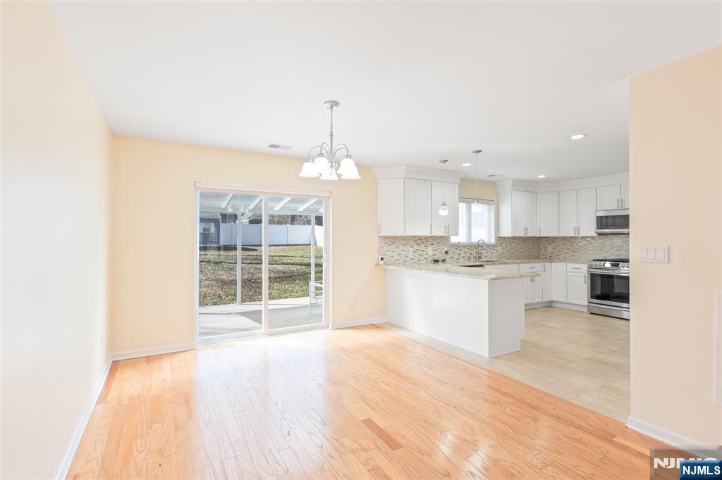 902 Spruce Street Roselle, NJ 07203 - Photo 5 of 32 a large kitchen with granite countertop a large counter top a sink stainless steel appliances and cabinets