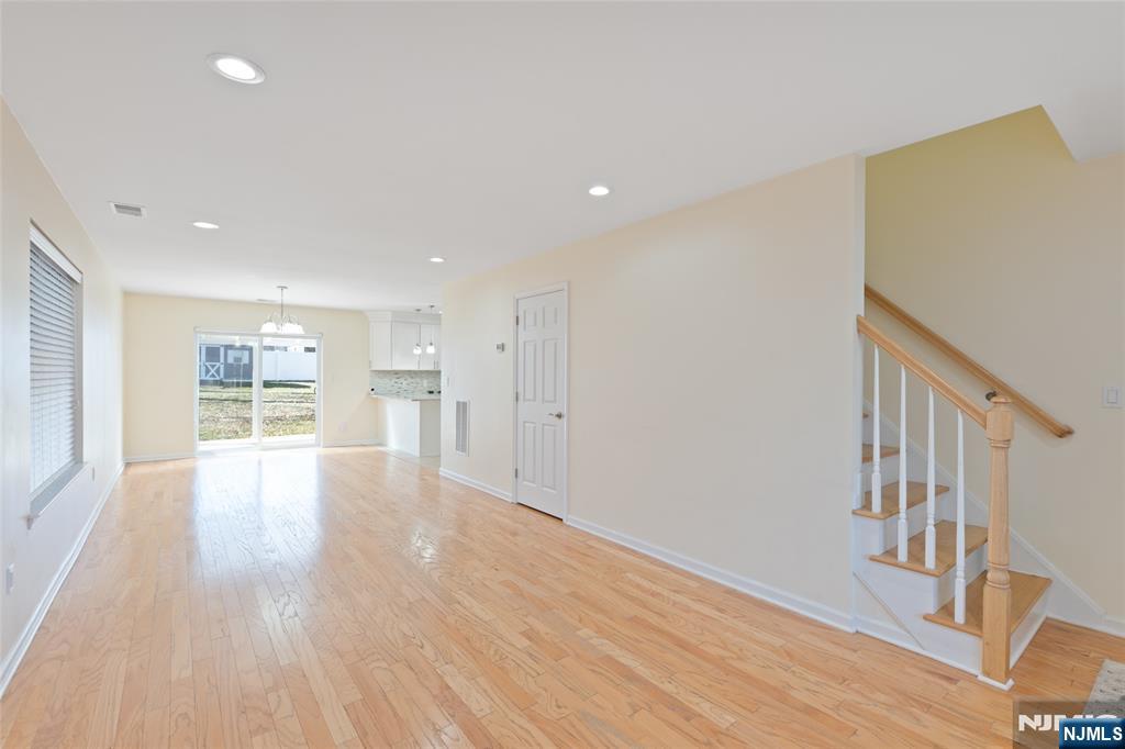 902 Spruce Street Roselle, NJ 07203 - Photo 6 of 32 a view of an empty room with wooden floor and a window