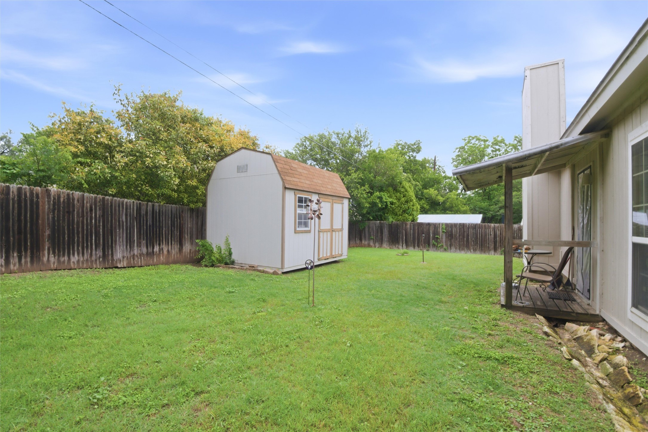 2000 Magazine Street Austin, TX 78727 - Photo 28 of 30 A spacious backyard provides ample green space, secured by sturdy fencing and offering a convenient storage shed.