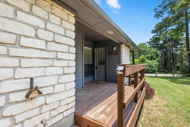 a view of a porch with wooden floor and fence