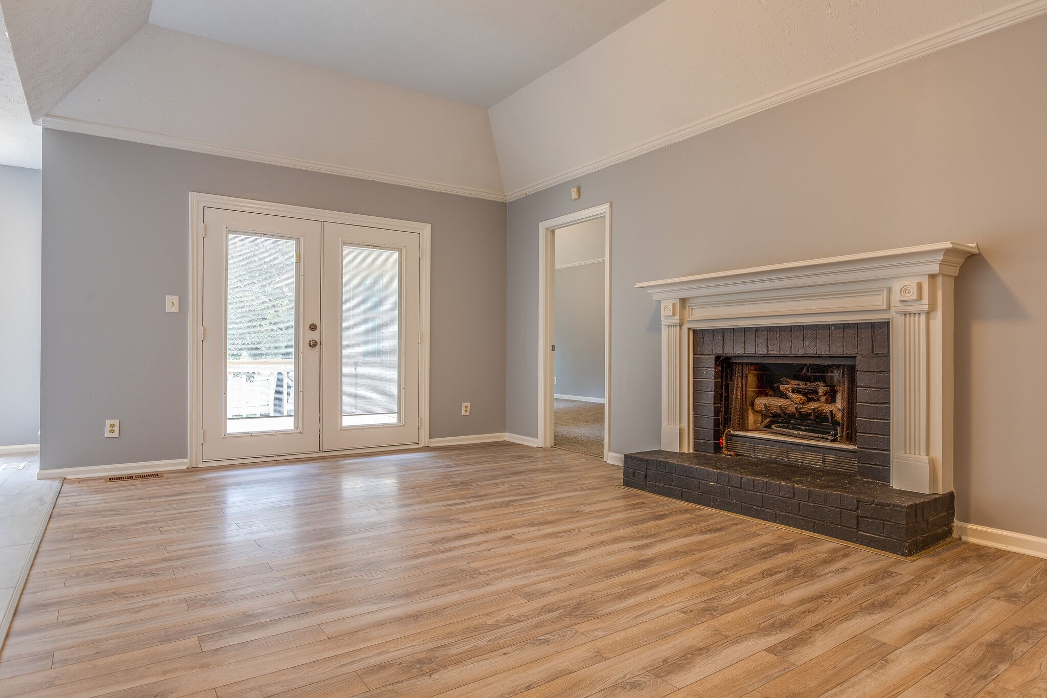 3218 Country Hill Road Antioch, TN 37013 - Photo 5 of 22 wooden floor fireplace and windows in an empty room