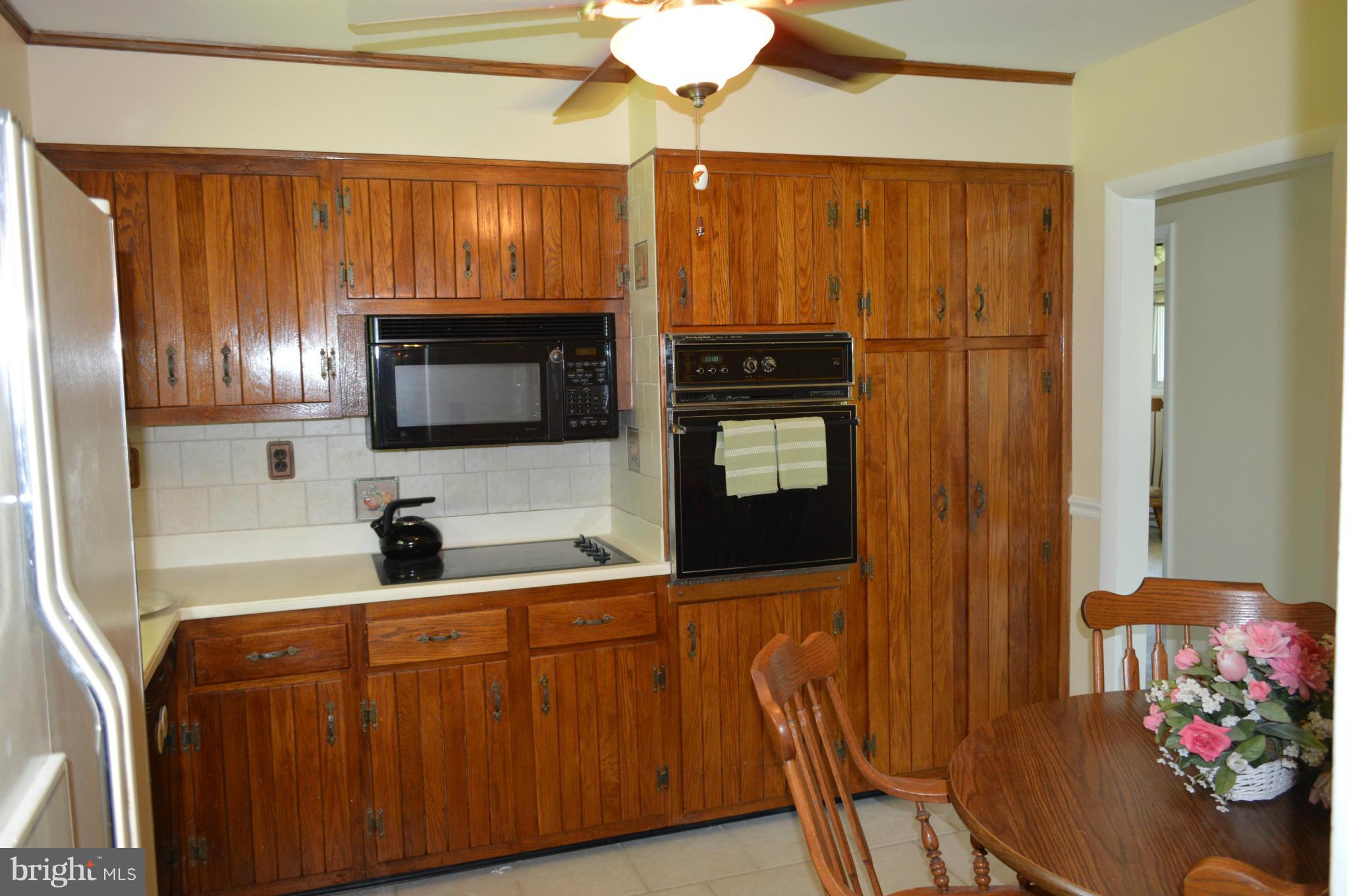 2308 Reckord Road Joppa, MD 21085 - Photo 7 of 17 a kitchen with stainless steel appliances a microwave a stove and a refrigerator