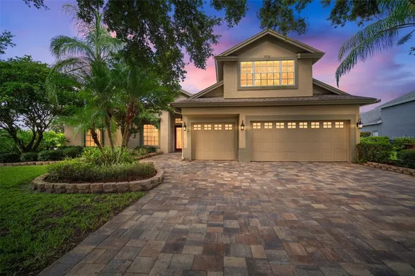 a view of a house with a yard and garage