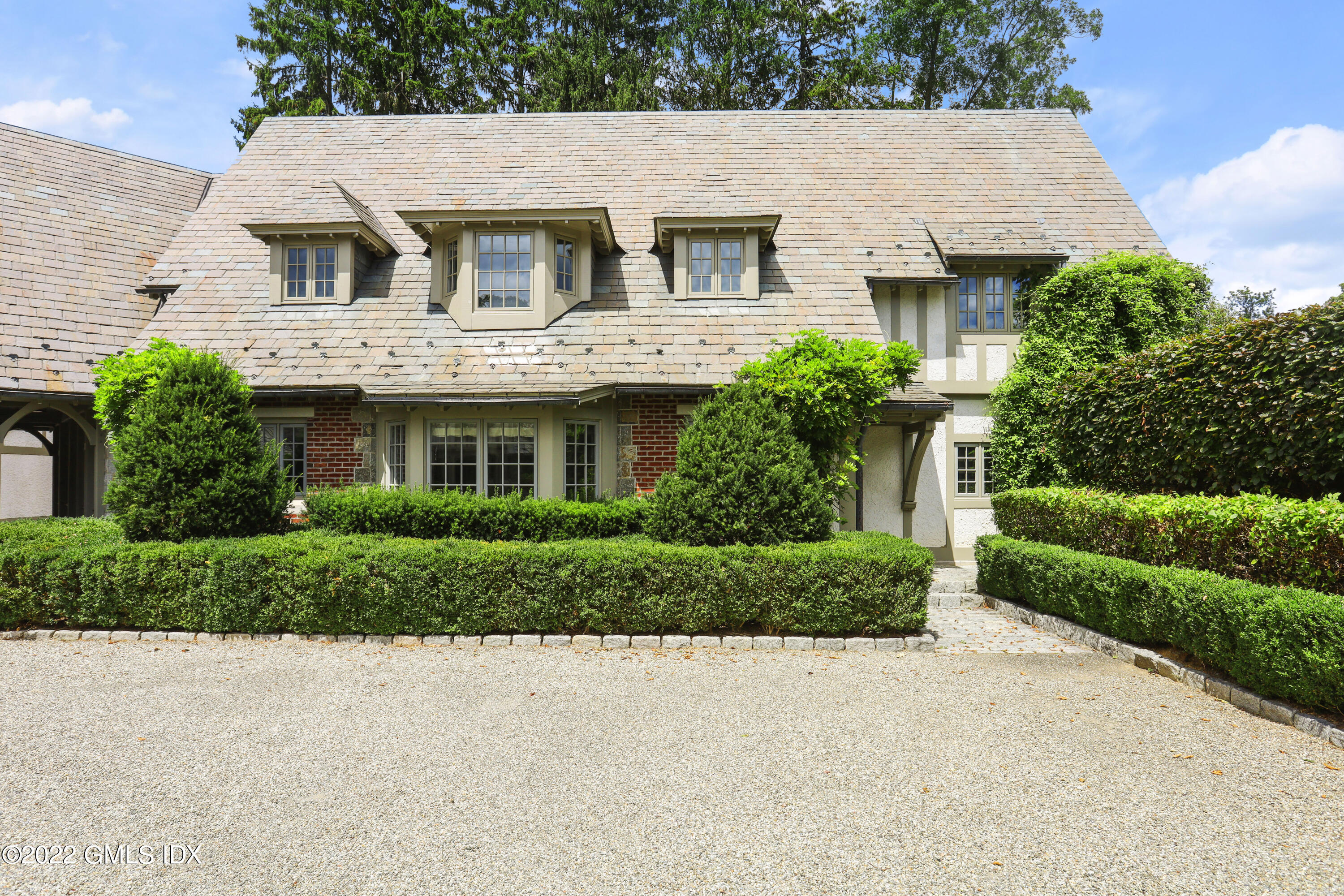164 Round Hill Road Greenwich, CT 06831 - Photo 61 of 67 a front view of a house with a yard